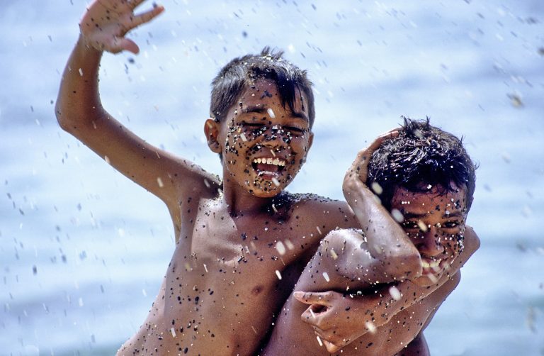Children playing in the sea. Ceram island(Amahai). Moluccas island. Indonesia